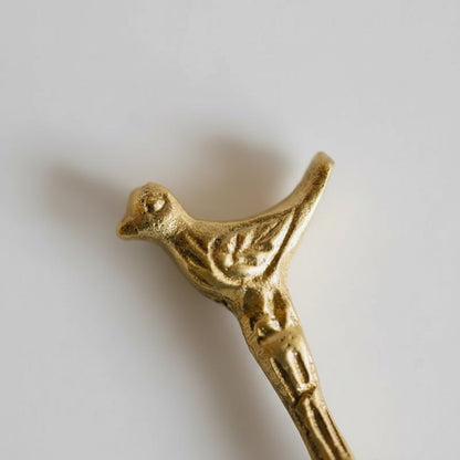 Gold bird-shaped brass coat hook in sleek modern design