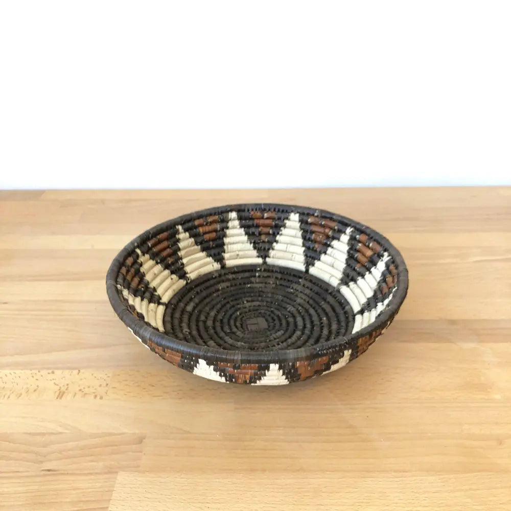 Assorted handmade African baskets in various natural colors with striking geometric designs.