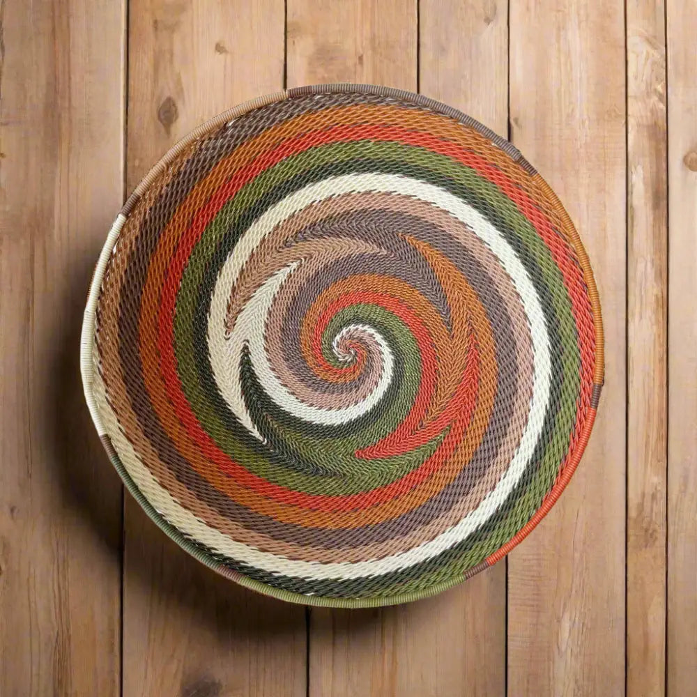 Vibrant African Zulu wire bowl handwoven from recycled telephone wire with spiral pattern