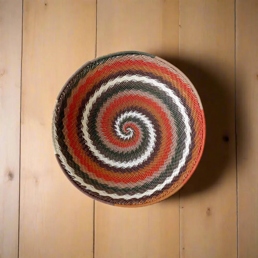 African Zulu wire bowl handwoven from recycled telephone wire with colorful spiral pattern