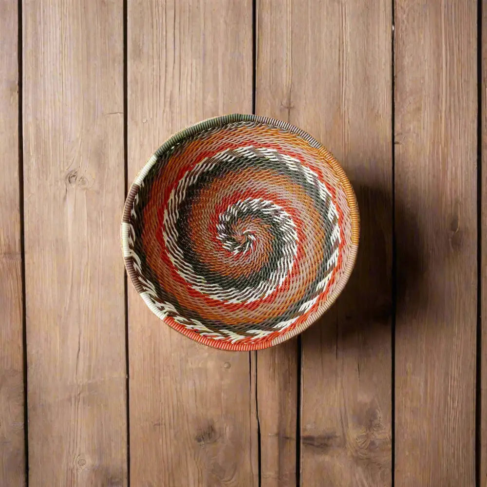 Colorful coiled African Zulu wire bowl woven from recycled telephone wire