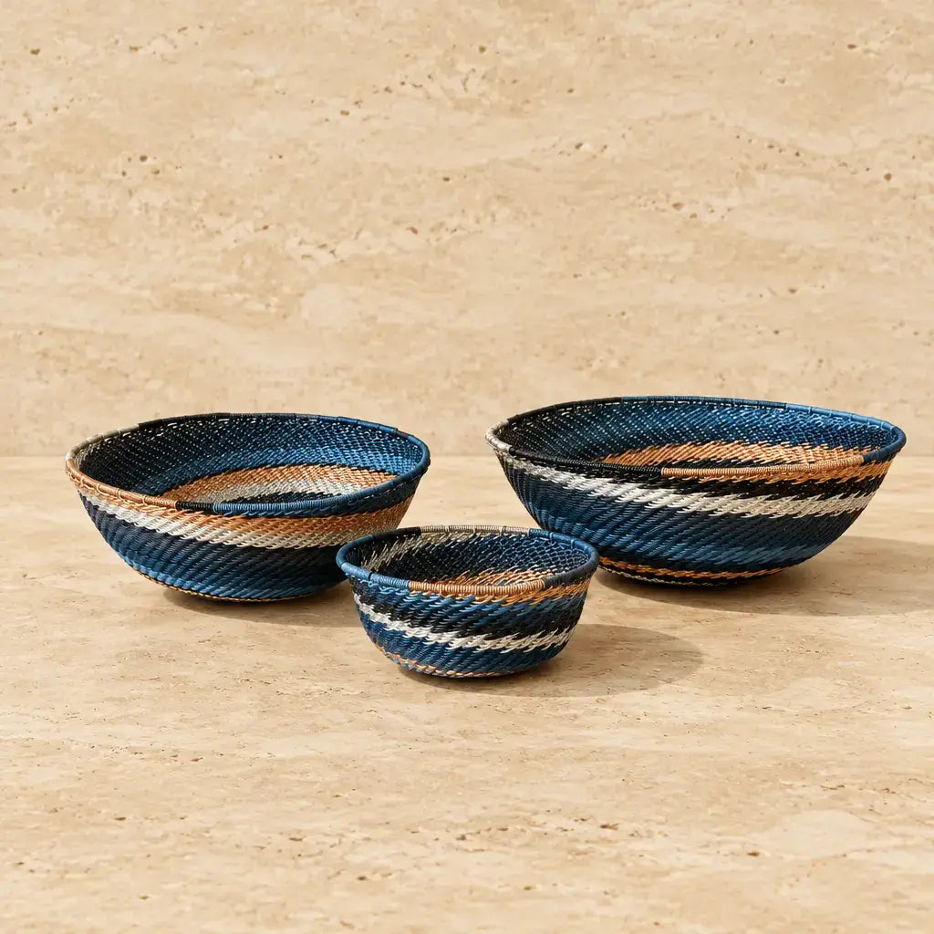 Handwoven african zulu bowls in blue white and tan stripes made from recycled telephone wire city lights design