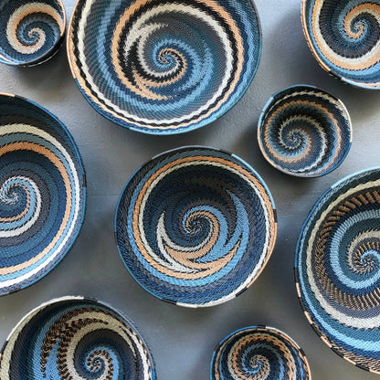 Colorful South Africa city lights woven baskets with spiral patterns in blue black tan