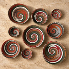 Handwoven african zulu wire bowls in spiral patterns with earthy red green white and brown from recycled telephone wire