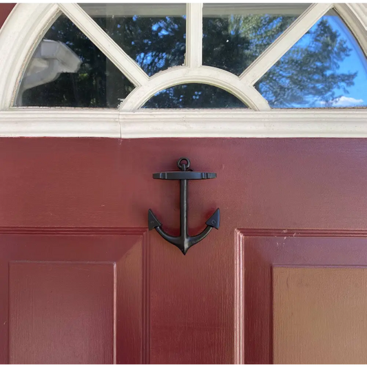 Red door with a black anchor-shaped knocker