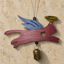 Painted angel cat bell chime ornament with blue wings yellow halo heart cutout and rust patina bell hanging from string