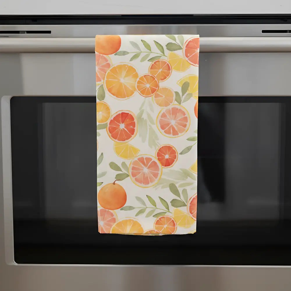 Artisan tea towel with citrus fruit design features vibrant orange grapefruit and lemon slices on cream flour sack fabric
