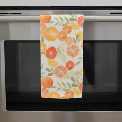 Artisan tea towel with citrus fruit design features vibrant orange grapefruit and lemon slices on cream flour sack fabric