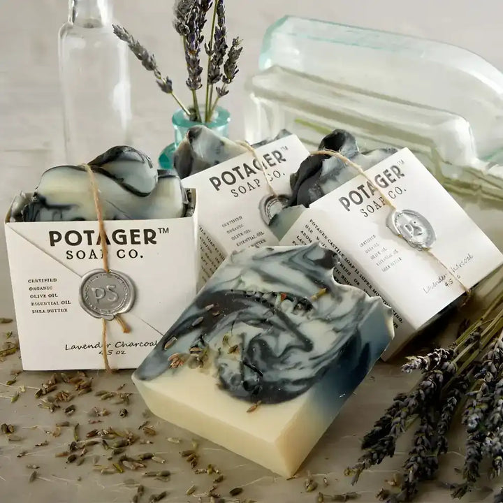 Four Lavender Charcoal Wrapped on a counter with lavender sprigs