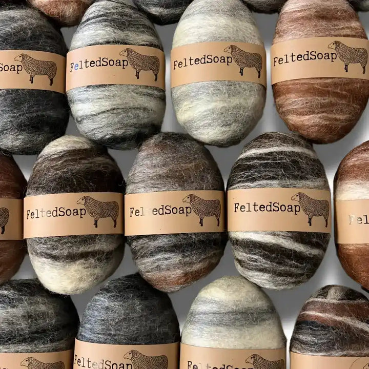 Bars of soap wrapped in natural tones colored wool.