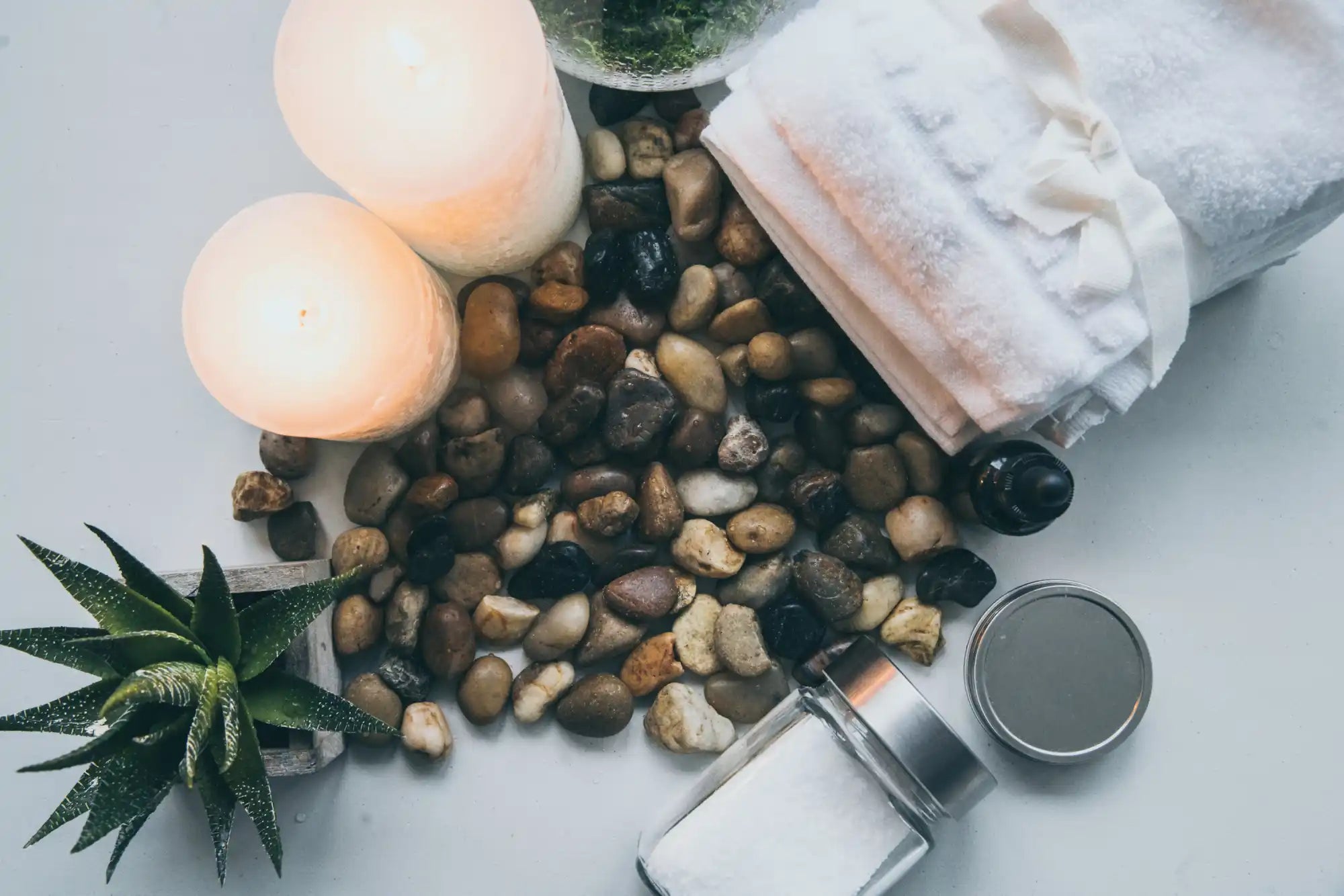 Assortment of spa and relaxation items including candles, towels, and bath salts.