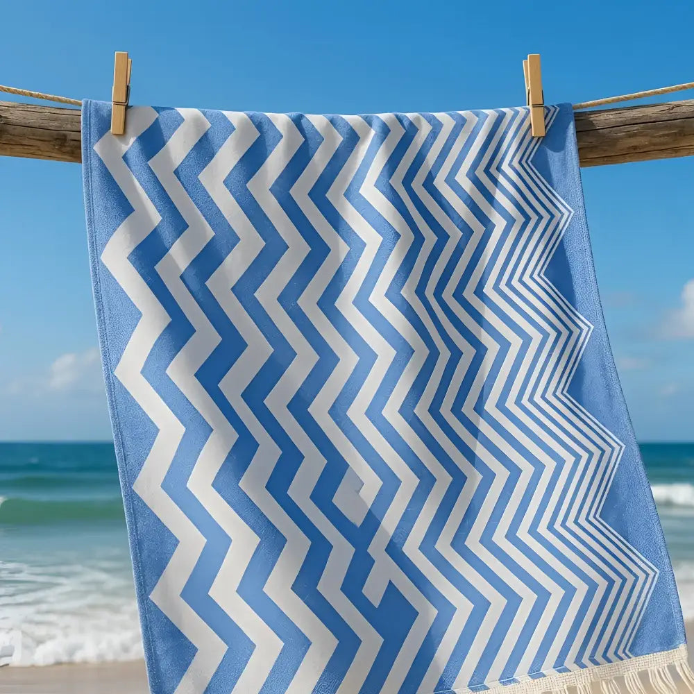Authentic turkish organic cotton beach towel with blue and white zigzag pattern hanging on wooden clothesline