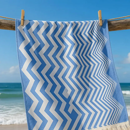 Authentic turkish organic cotton beach towel with blue and white zigzag pattern hanging on wooden clothesline