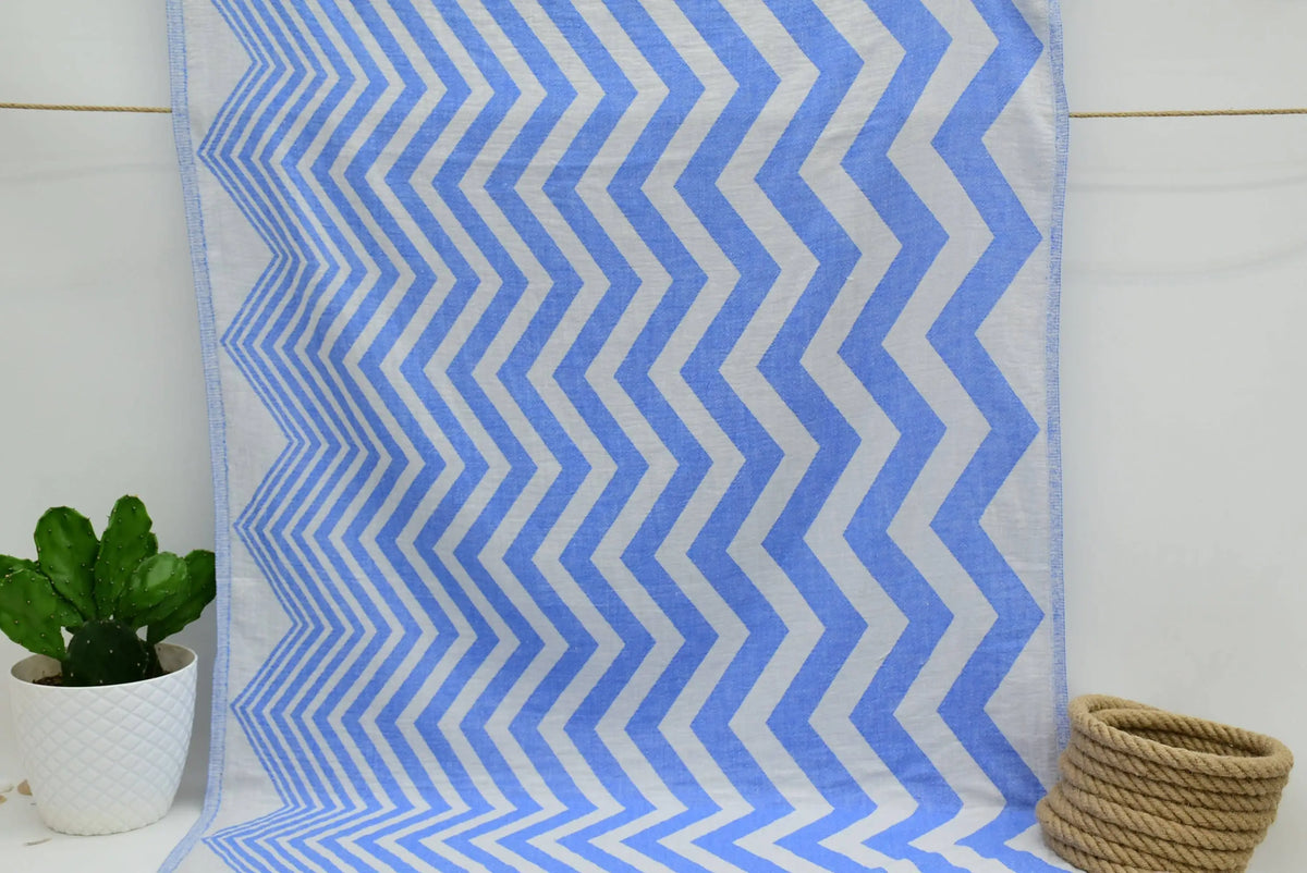 Turkish towel with a zigzag design in pale sax blue features a textured weave perfect for beach or bath use