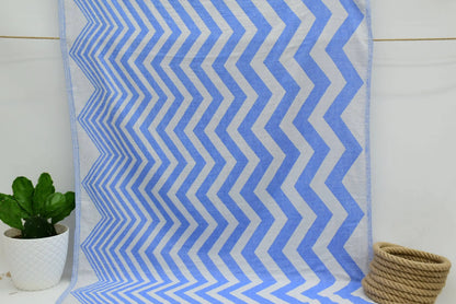 Turkish towel with a zigzag design in pale sax blue features a textured weave perfect for beach or bath use