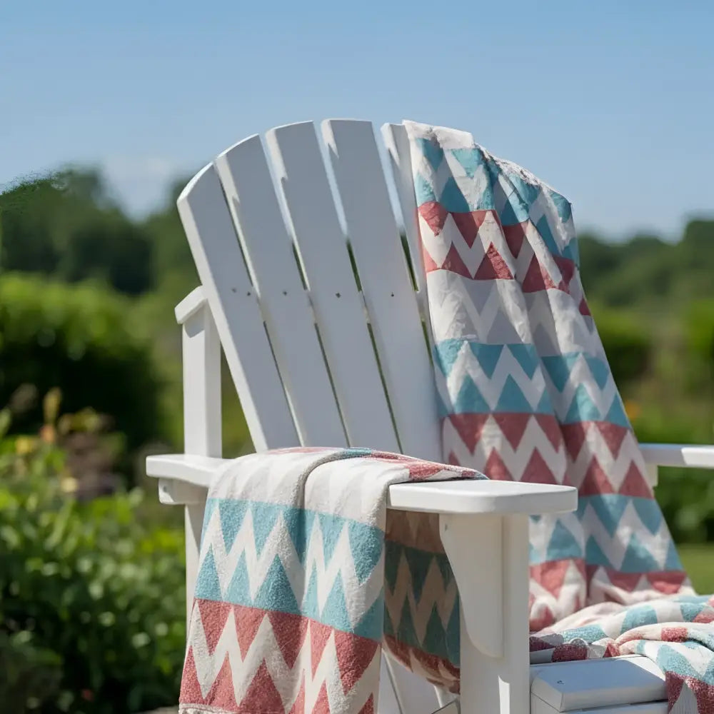 White wooden adirondack chair with authentic turkish organic cotton beach towel in turquoise and clay zigzag pattern