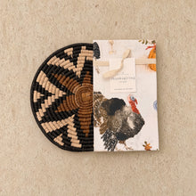 Handwoven african zulu trivet with black beige and brown geometric pattern paired with autumn tea towel