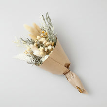 Four handcrafted eco-friendly baby bouquets of dried flowers in kraft paper