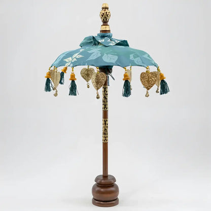 Balinese tabletop umbrella blue and green floral with teal fabric, gold embossed hearts, and tassels for grace temple ceremonies ornamental parasols