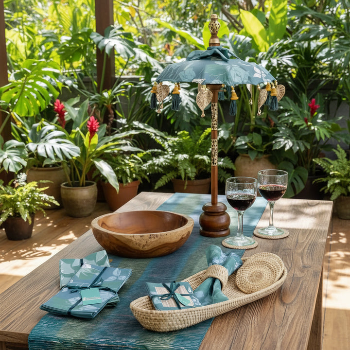 Balinese tabletop umbrella blue and green floral with teal gold pattern tassels and wooden pole inspired by ornamental parasols on a tropical lanai with plants