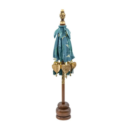 Balinese tabletop umbrella blue and green floral with teal fabric, gold heart ornaments, and tassels for grace temple ceremonies