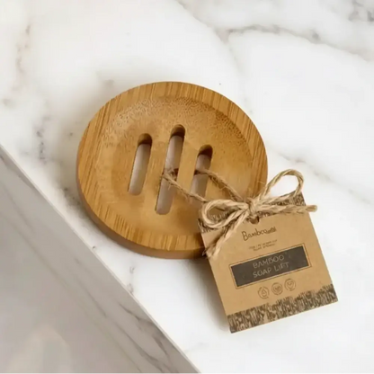 Bamboo soap lifter with natural wood finish and three vertical slots tied to tag by twine for bamboo shower steamer use