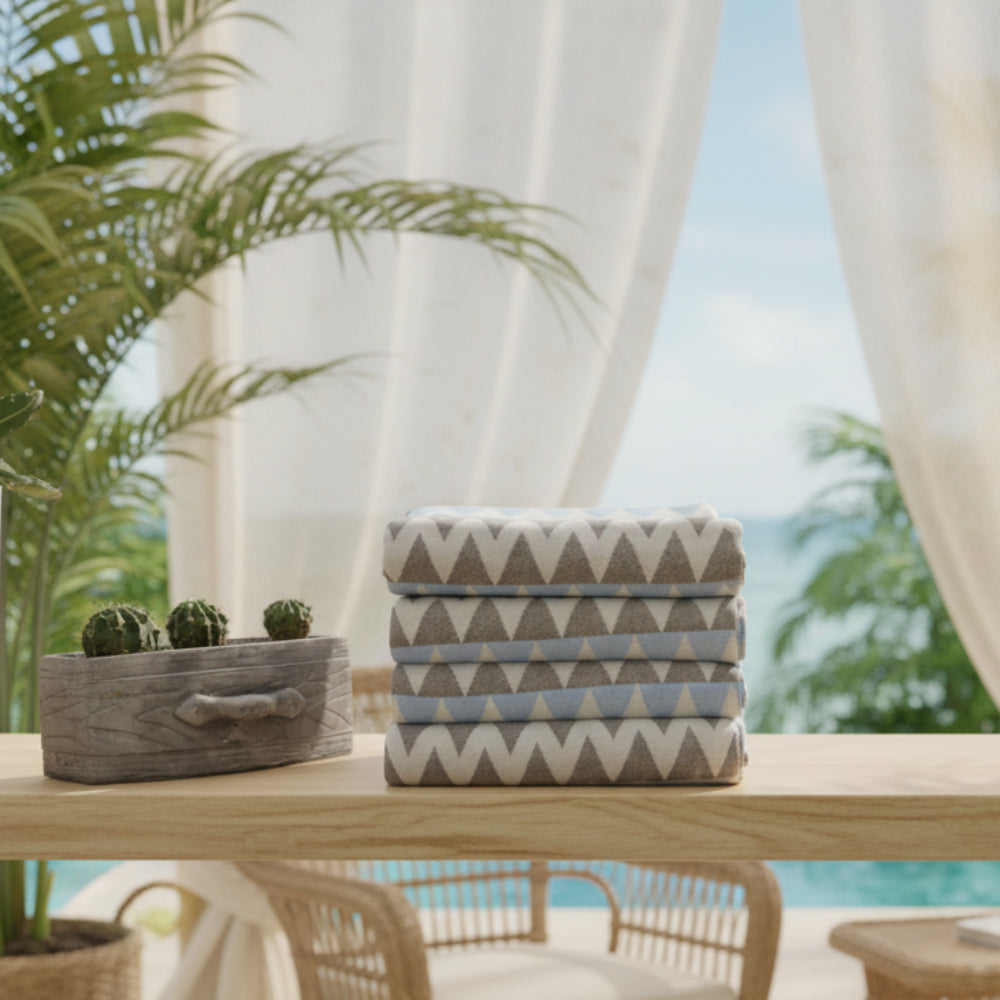 Stack of folded organic turkish towels with gray white and light blue zigzag pattern beach towel 36x78