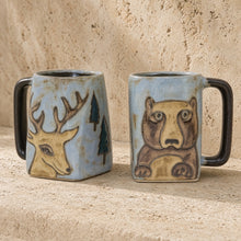 Hand-painted stoneware mug with deer and bear designs on light blue glaze and dark brown handles sturdy and unique