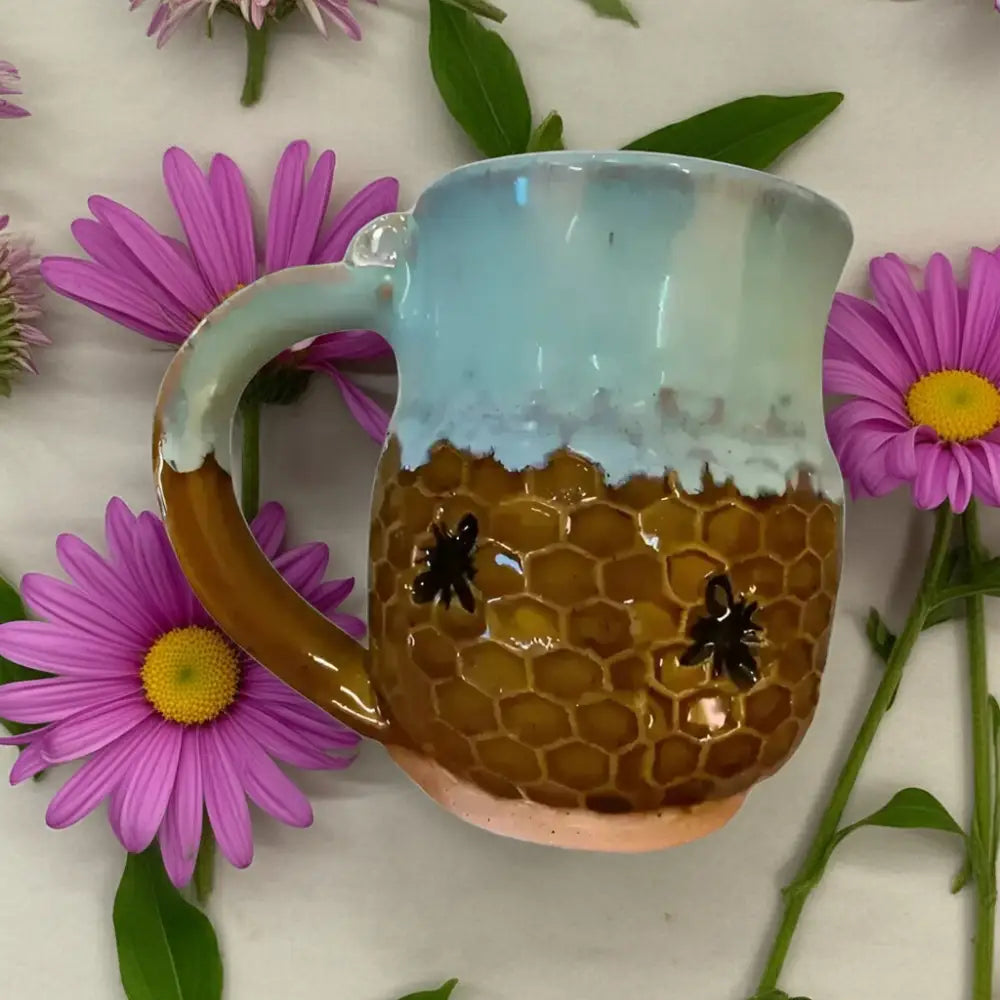 Cute handmade pottery mug with adorable bee design and honeycomb pattern