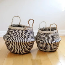 Woven seagrass belly basket in black and natural zig zag pattern with two handles.