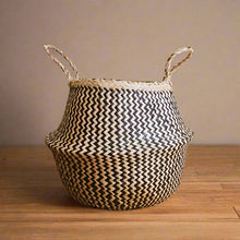 Hand-woven belly basket with black zig-zag pattern and two handles, handmade basket style