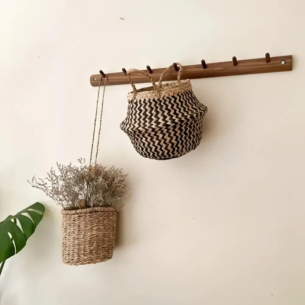 Woven seagrass belly basket in black and natural zig zag pattern with two handles.