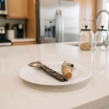 Zebra print bike chain bottle opener with brown leather strap