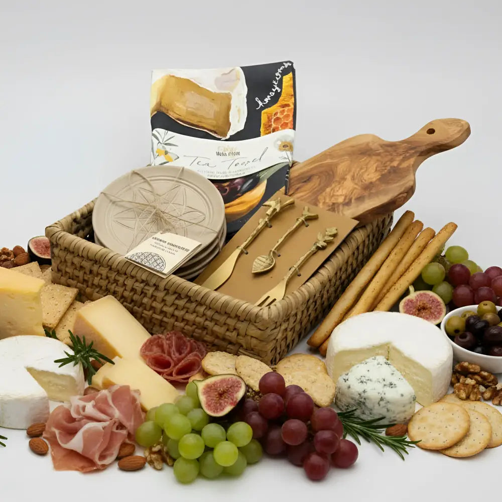 Bird Feeder Nest wicker basket with cheeses, crackers, grapes, appetizer plates, tea towel