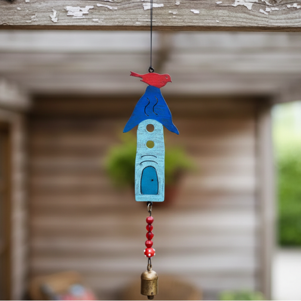 A handmade eco-friendly blue metal birdhouse wind chime with red bird, white cutouts, beads and bronze bell