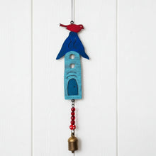 A whimsical handmade blue and red metal birdhouse wind chime with eco-friendly beads and hanging bell for outdoor decor