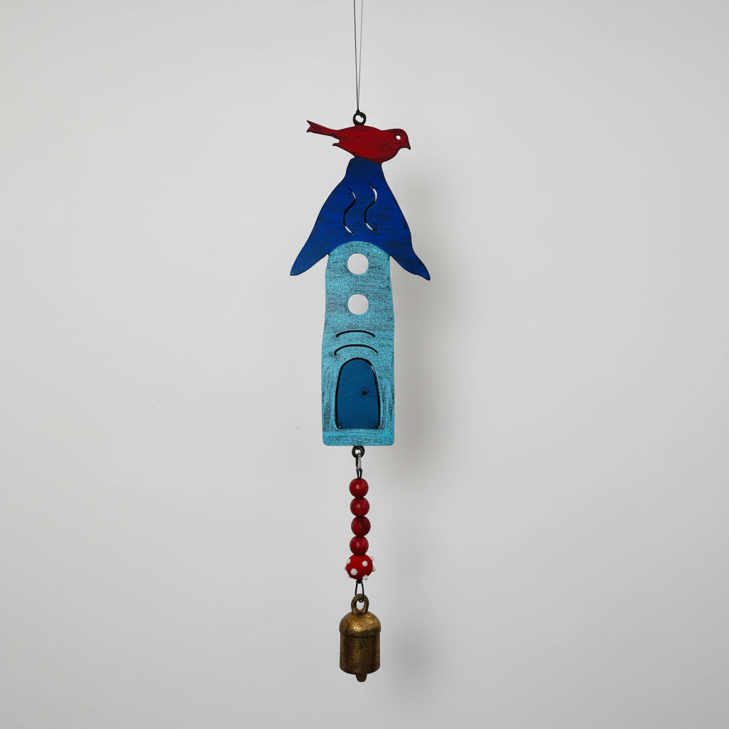 A handmade vibrant blue metal birdhouse wind chime with red bird, red beads, and eco-friendly brass bell detail