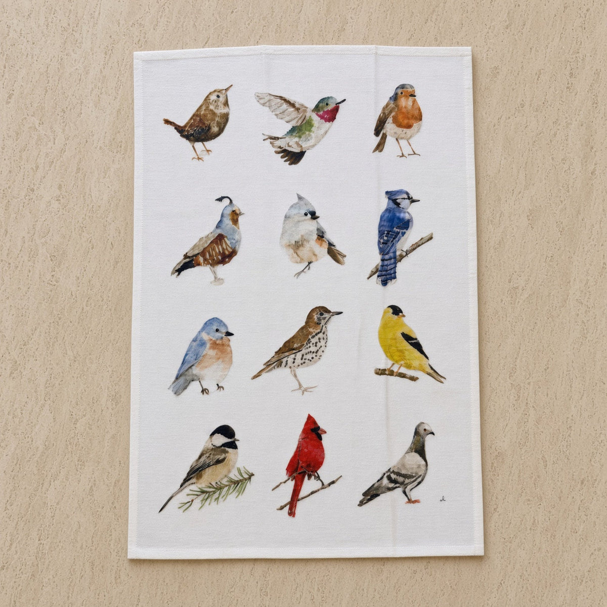 White cotton flour sack tea towel with watercolor illustrations of twelve different birds in naturalistic poses