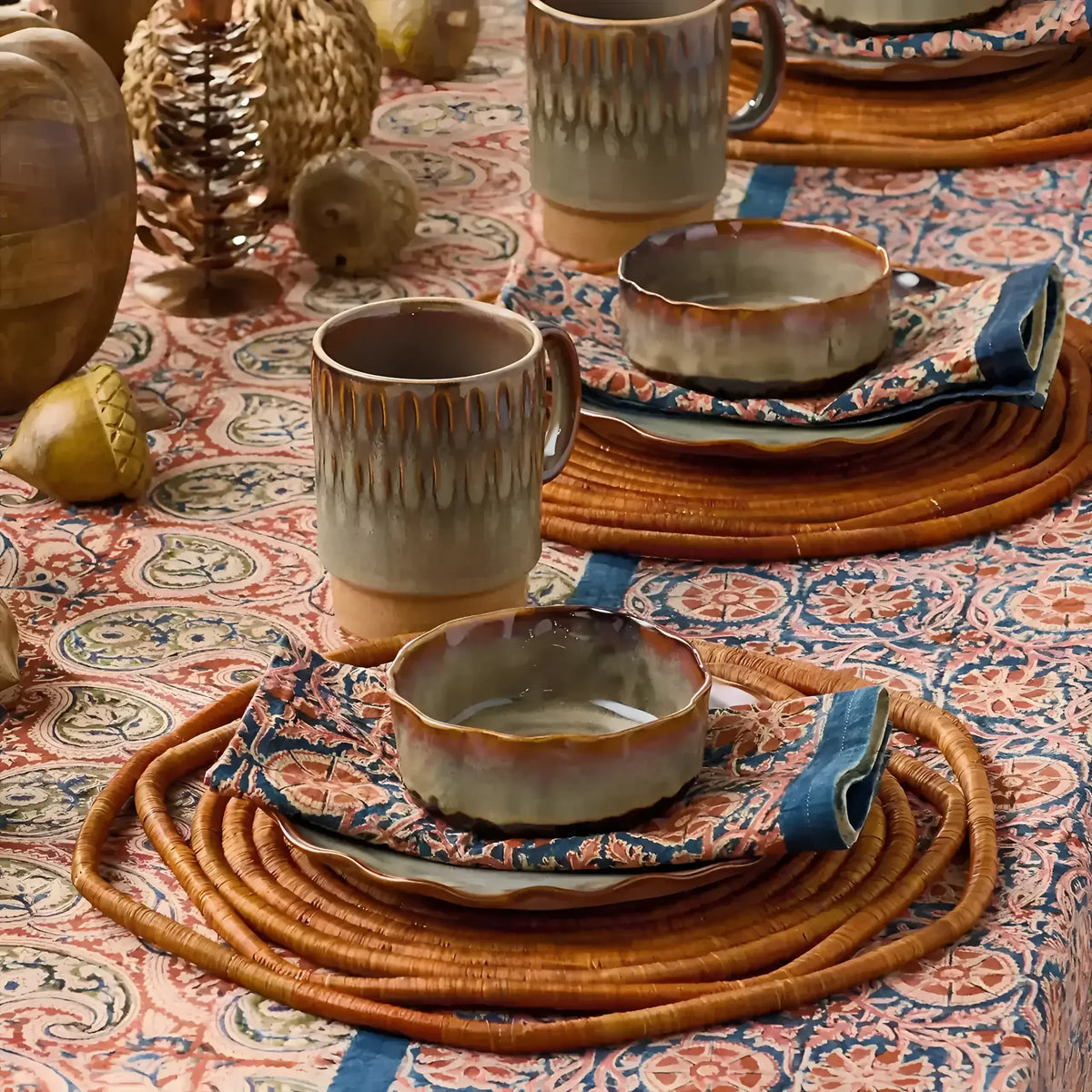 Ceramic dinnerware set with reactive glaze in earthy tones for Compass Paisley Napkins