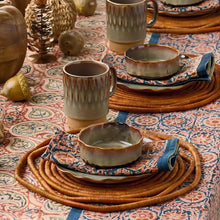 Ceramic dinnerware set with reactive glaze in earthy tones for Compass Paisley Napkins