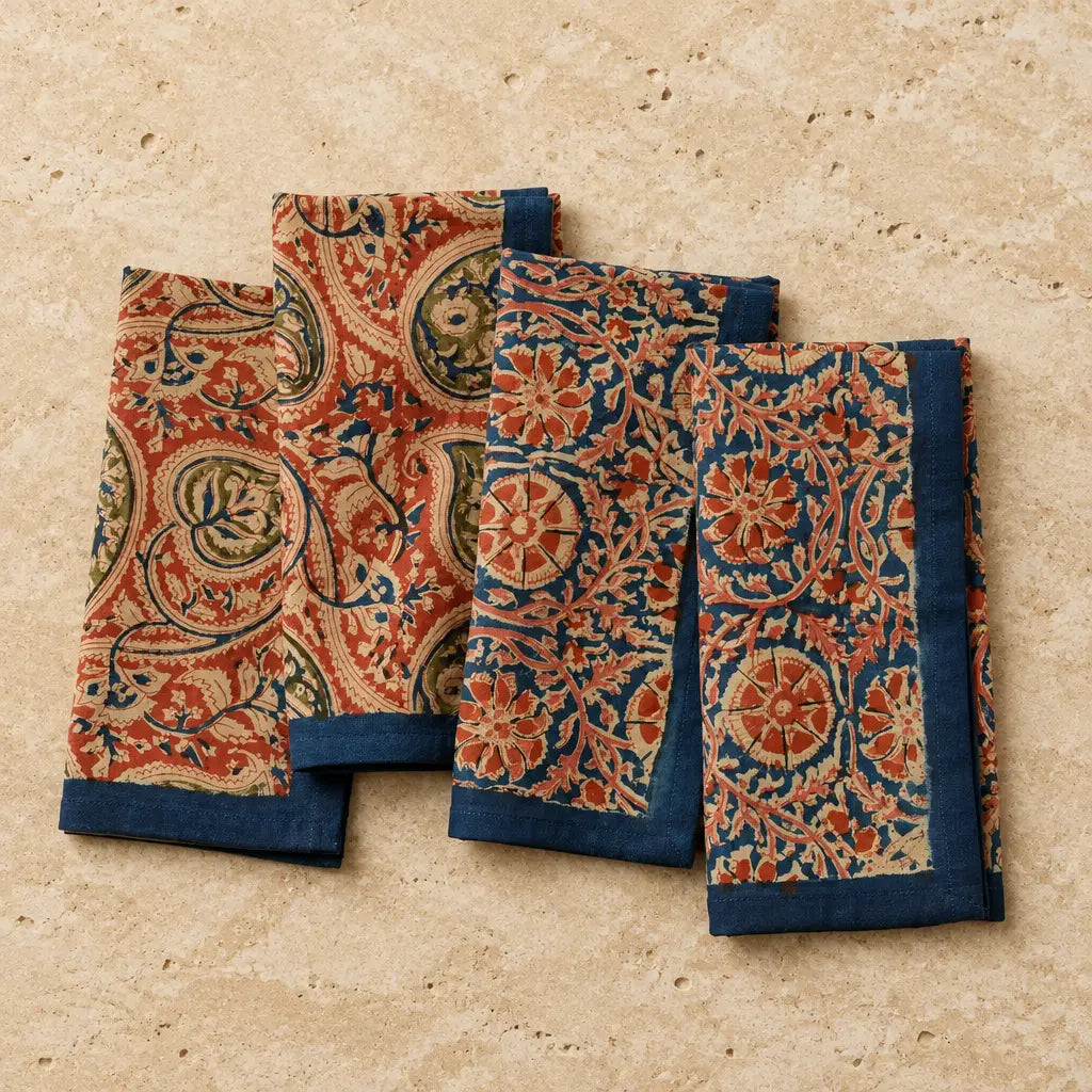 Set of four hand-block printed cotton compass paisley napkins with rust navy blue and beige floral patterns