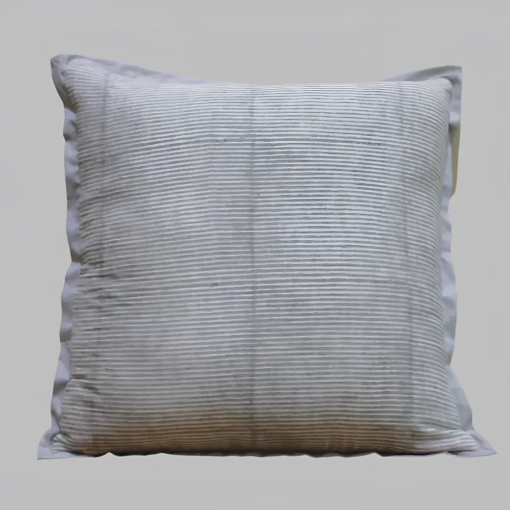 Pillow cover features a green colored cotton gauze material with a hand block print design in a neutral color and has a zipper closure on the back side.