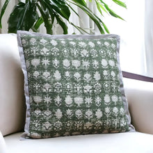 Pillow cover features a green colored cotton gauze material with a hand block print design in a neutral color and has a zipper closure on the back side.