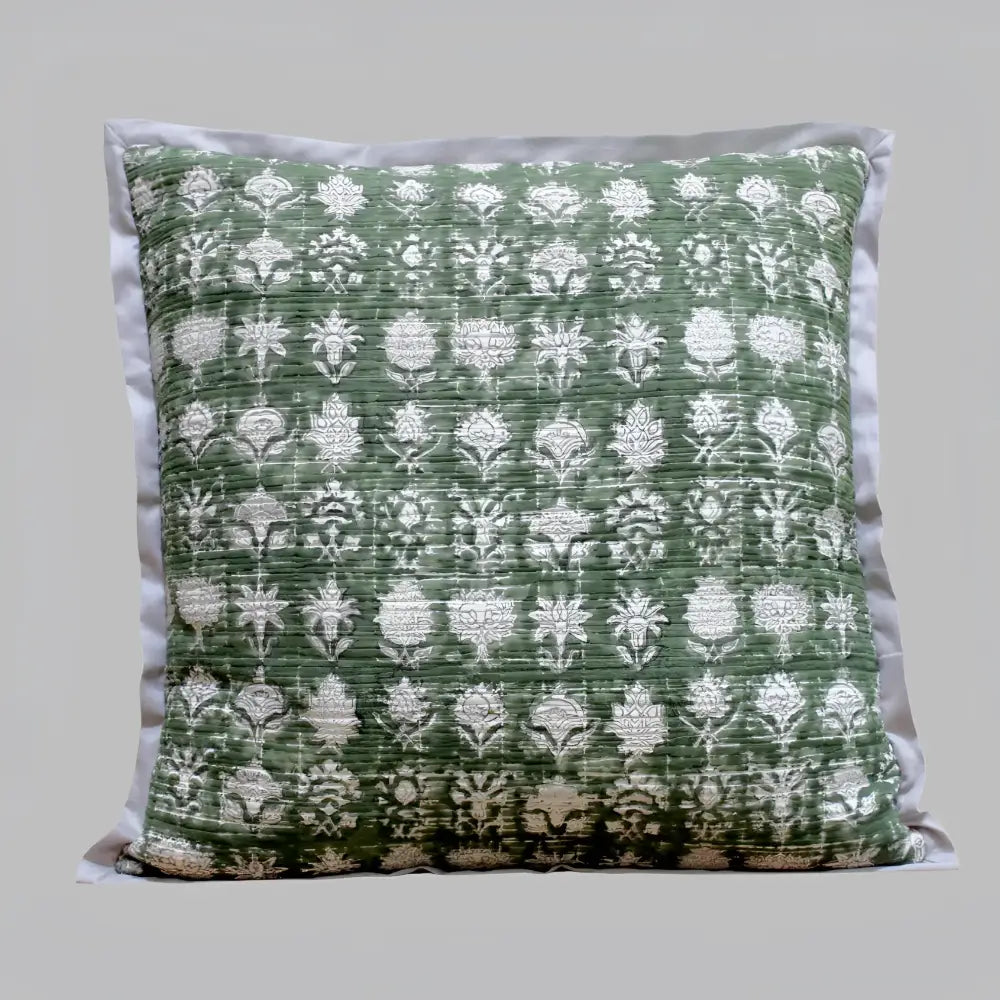 Pillow cover features a green colored cotton gauze material with a hand block print design in a neutral color and has a zipper closure on the back side.