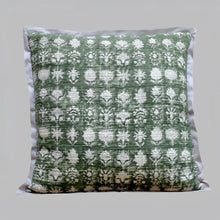 Pillow cover features a green colored cotton gauze material with a hand block print design in a neutral color and has a zipper closure on the back side.