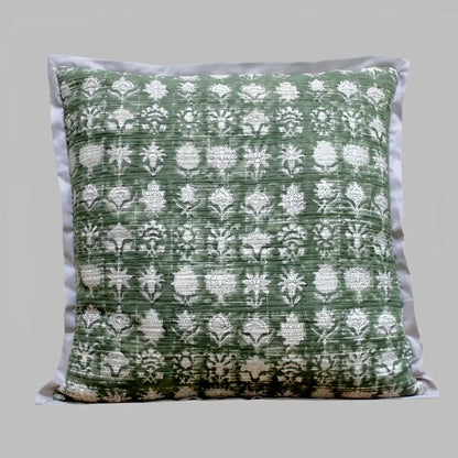Pillow cover features a green colored cotton gauze material with a hand block print design in a neutral color and has a zipper closure on the back side.