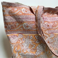 Large canvas tote bag with hand block printed design in orange and natural tones.