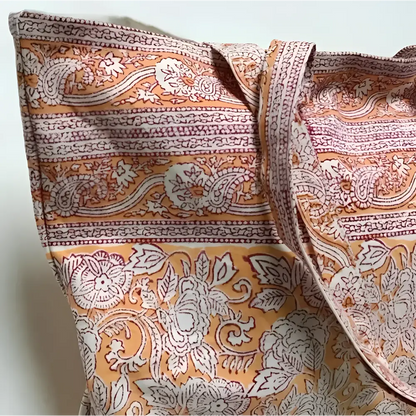 Large canvas tote bag with hand block printed design in orange and natural tones.