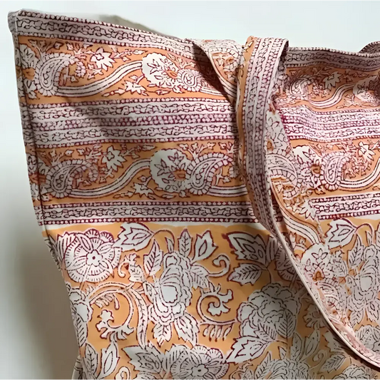 Large canvas tote bag with hand block printed design in orange and natural tones.