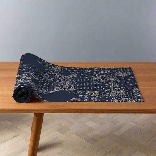 Dark blue bandana table runner with lively pattern, partially unrolled yoga mat style